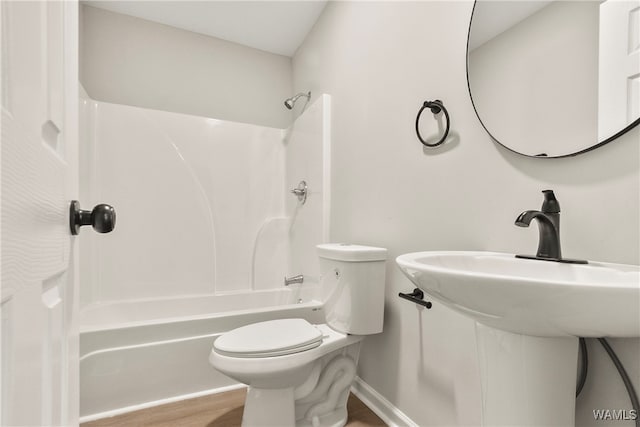 bathroom featuring shower / tub combination, hardwood / wood-style floors, and toilet