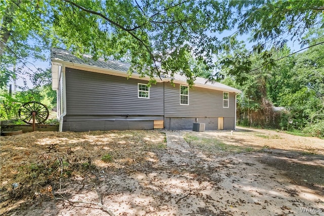 view of side of home with central air condition unit