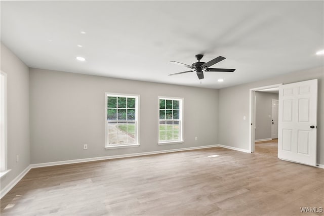 spare room featuring ceiling fan and light hardwood / wood-style flooring