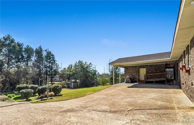 exterior space with concrete driveway and a lawn