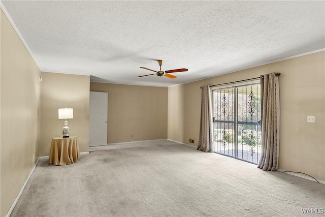 empty room with light colored carpet, a ceiling fan, and a textured ceiling