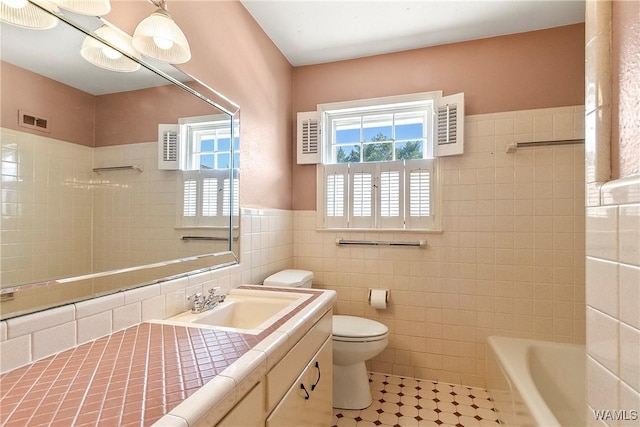 full bath featuring visible vents, a tub, a shower, tile walls, and toilet