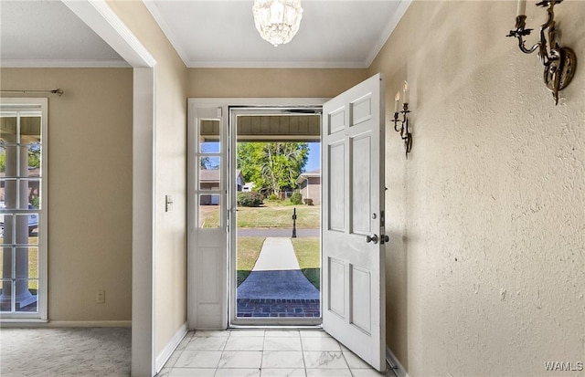 entryway with a notable chandelier, a healthy amount of sunlight, and crown molding