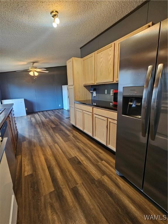 kitchen with a textured ceiling, dark hardwood / wood-style flooring, stainless steel refrigerator with ice dispenser, and light brown cabinets