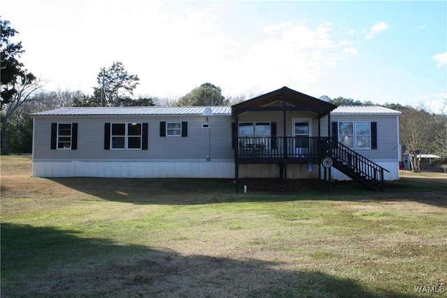 rear view of property featuring a lawn