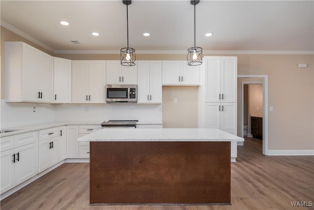 kitchen with white cabinets, hanging light fixtures, and appliances with stainless steel finishes