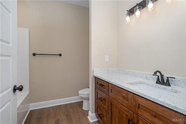 bathroom featuring hardwood / wood-style floors, toilet, and vanity