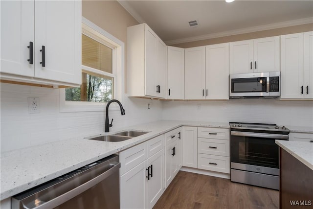 kitchen featuring dark hardwood / wood-style flooring, sink, white cabinetry, light stone countertops, and stainless steel appliances