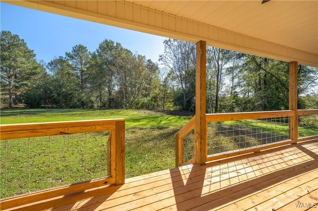 wooden terrace featuring a yard