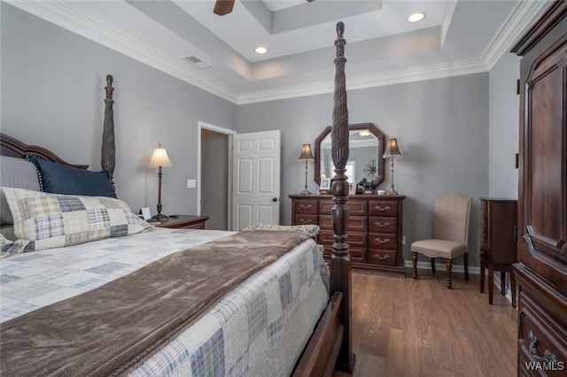 bedroom featuring a raised ceiling, ceiling fan, crown molding, and dark wood-type flooring