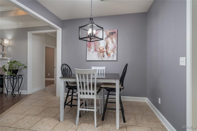 dining room featuring an inviting chandelier, ornamental molding, and light tile patterned flooring