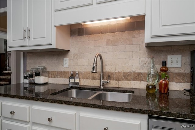 kitchen with tasteful backsplash, dark stone counters, sink, dishwasher, and white cabinets