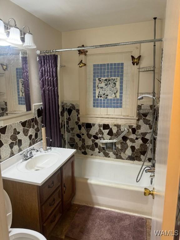 bathroom featuring shower / tub combo, vanity, and backsplash