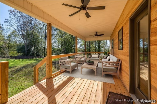 deck featuring a ceiling fan and an outdoor living space