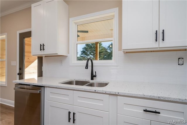 kitchen featuring white cabinets, dishwasher, ornamental molding, tasteful backsplash, and a sink