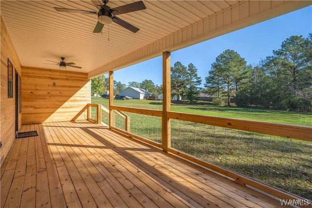 deck with a yard and ceiling fan