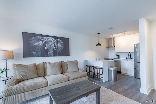 500 Grace St Unit 304, Tuscaloosa, AL 35401 - living area with track lighting and dark wood-style flooring