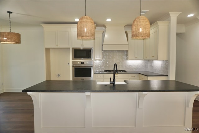 kitchen with appliances with stainless steel finishes, dark hardwood / wood-style floors, pendant lighting, and custom exhaust hood