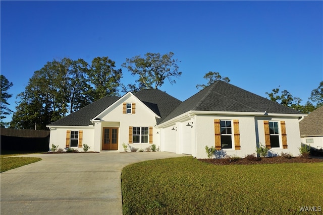 view of front of property with a front yard and a garage