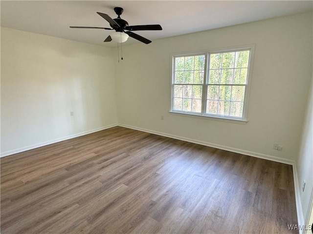 empty room with ceiling fan and wood-type flooring