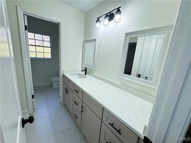 bathroom featuring vanity and toilet