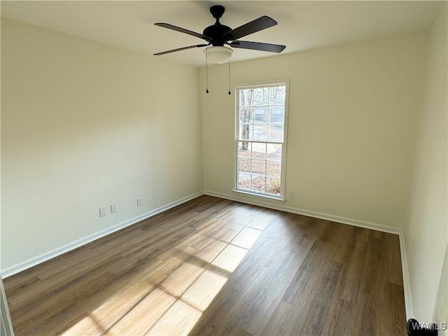 spare room featuring hardwood / wood-style flooring and ceiling fan