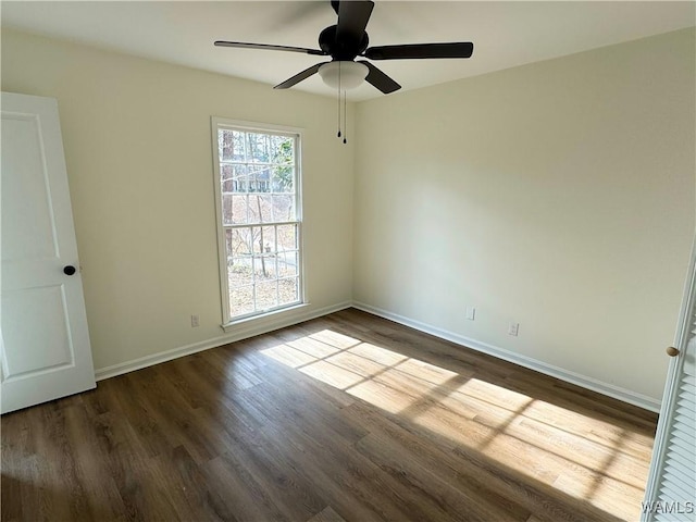 unfurnished room with dark hardwood / wood-style floors and ceiling fan