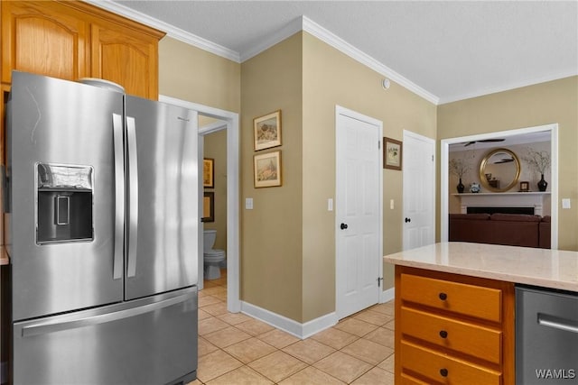 kitchen with ceiling fan, stainless steel fridge, crown molding, and light tile patterned floors