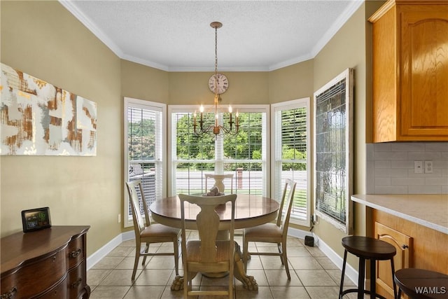 tiled dining room featuring a textured ceiling, ornamental molding, and a chandelier