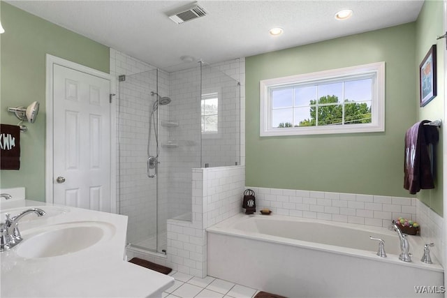 bathroom featuring vanity, tile patterned flooring, a textured ceiling, and separate shower and tub