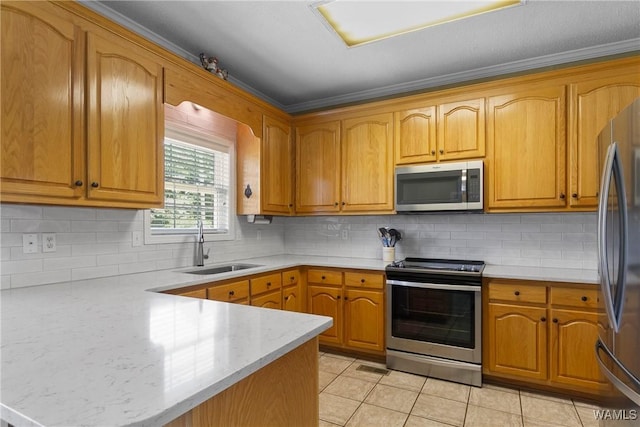 kitchen with sink, stainless steel appliances, light tile patterned flooring, and kitchen peninsula