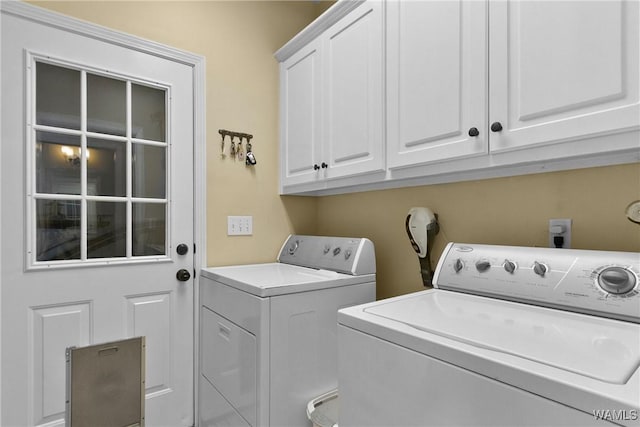 laundry area featuring cabinets and washing machine and dryer