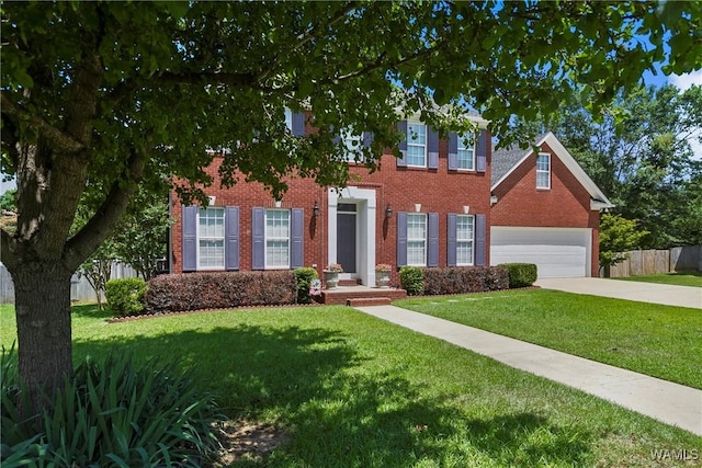 colonial inspired home with a front lawn and a garage