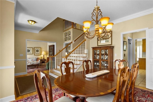 tiled dining room featuring ornamental molding and a notable chandelier