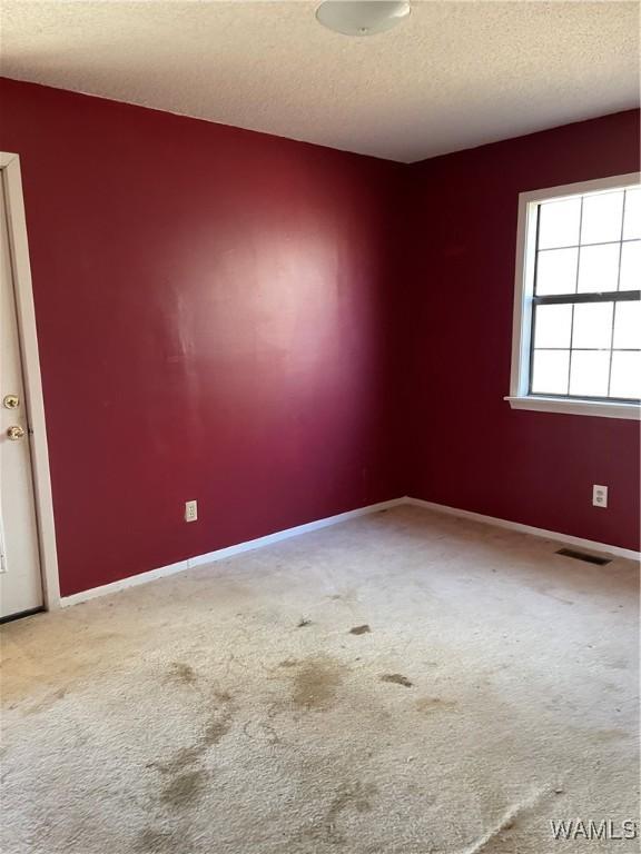 unfurnished bedroom with ceiling fan and light carpet