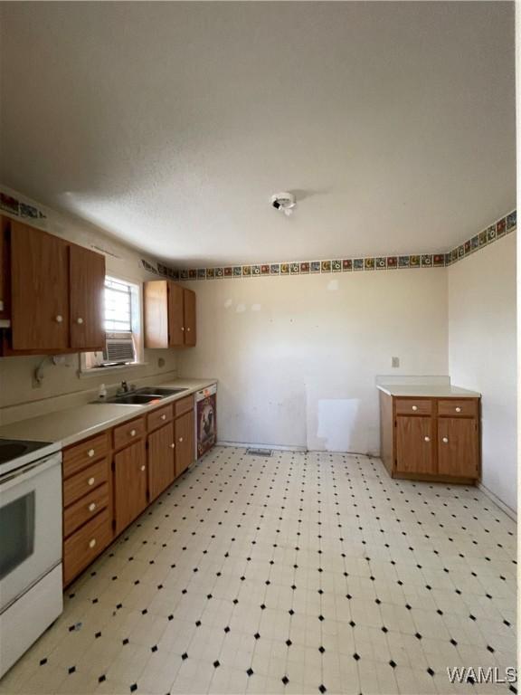 kitchen featuring dishwasher, sink, cooling unit, and white electric range