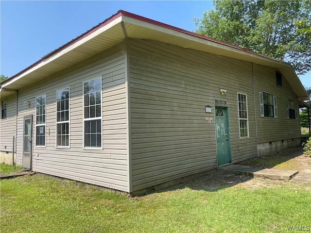 view of side of property with a yard