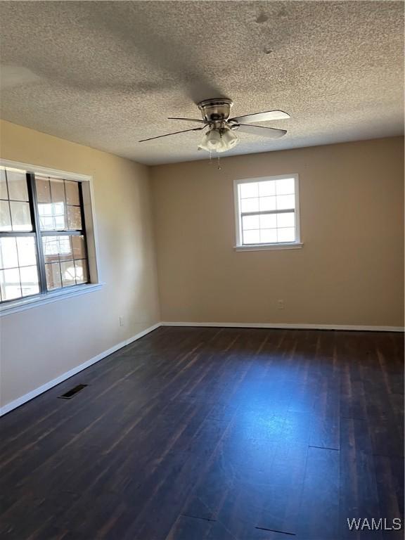 interior space featuring wood walls, a textured ceiling, and light carpet