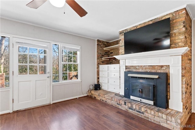 unfurnished living room featuring ornamental molding, a fireplace, dark wood finished floors, and a ceiling fan