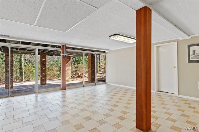 interior space with baseboards, floor to ceiling windows, and a wealth of natural light