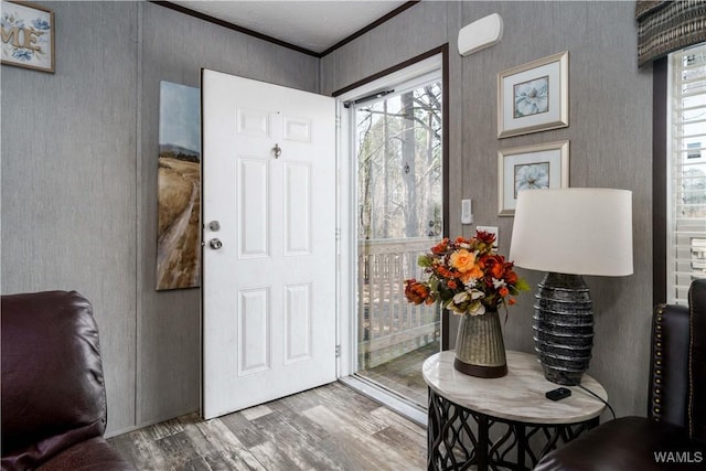 entryway with hardwood / wood-style flooring and ornamental molding