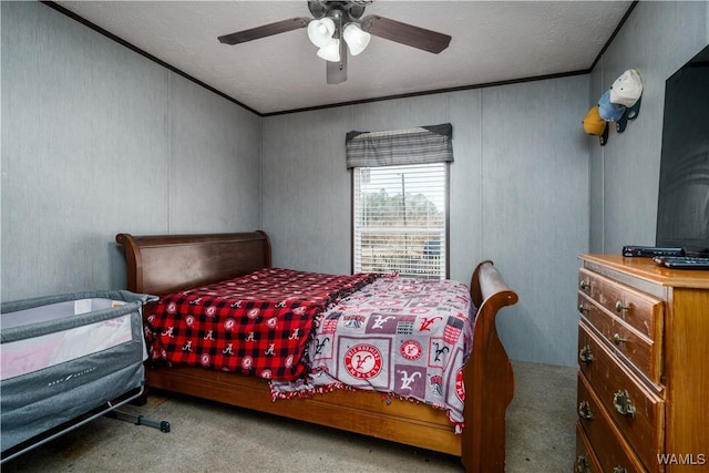 carpeted bedroom with crown molding and ceiling fan