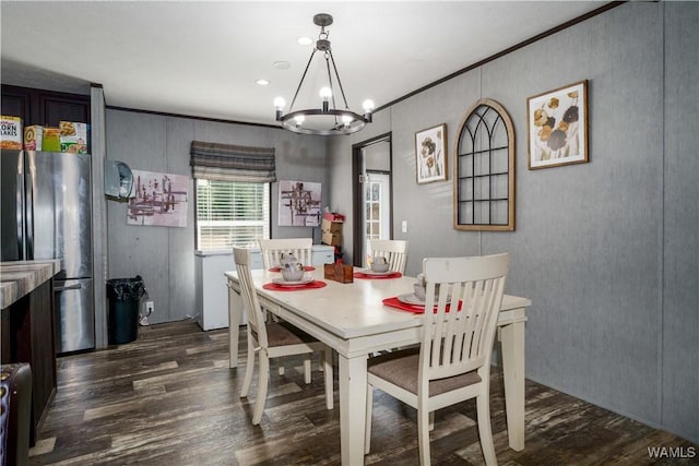 dining area with crown molding and dark hardwood / wood-style floors