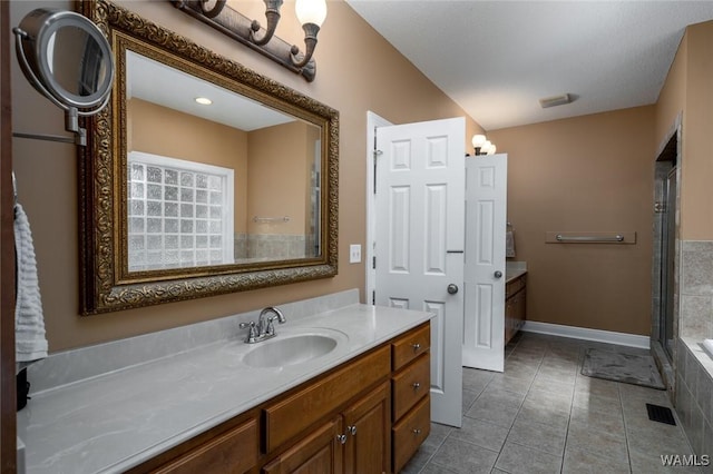 bathroom with vanity, plus walk in shower, and tile patterned flooring