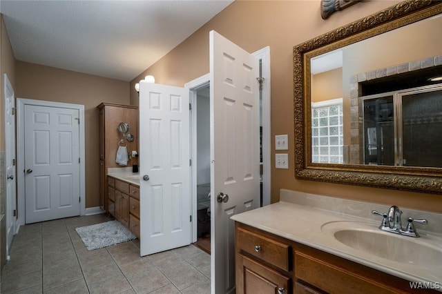 bathroom featuring vanity, tile patterned floors, and walk in shower
