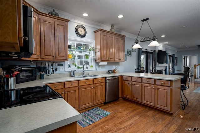 kitchen featuring decorative light fixtures, sink, stainless steel dishwasher, kitchen peninsula, and light wood-type flooring