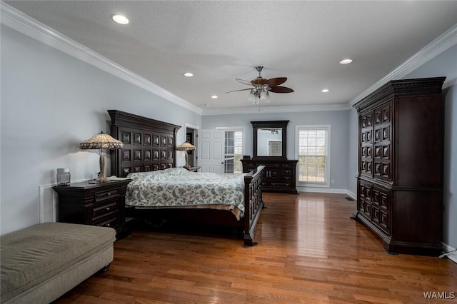 bedroom with dark hardwood / wood-style flooring, crown molding, and ceiling fan