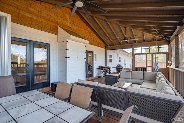 sunroom featuring french doors, ceiling fan, wood ceiling, and lofted ceiling with beams