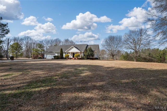 view of front of property featuring a garage and a front yard