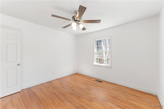 unfurnished room with baseboards, ceiling fan, visible vents, and light wood-style floors